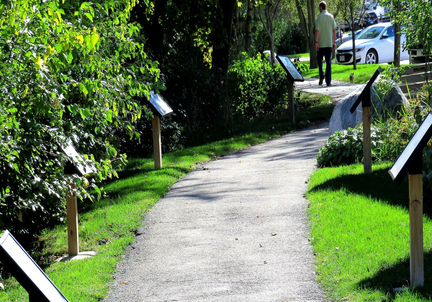 StoryWalk panels installed along a paved park path